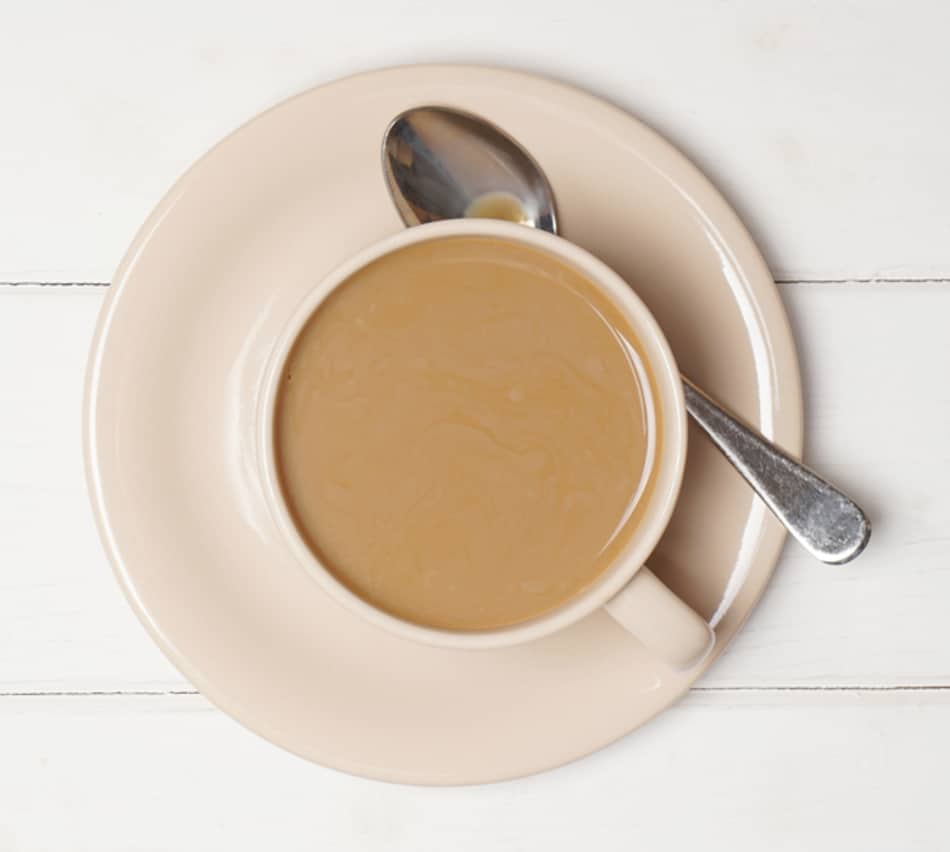 cafe au lait - milky coffee with spoon on saucer