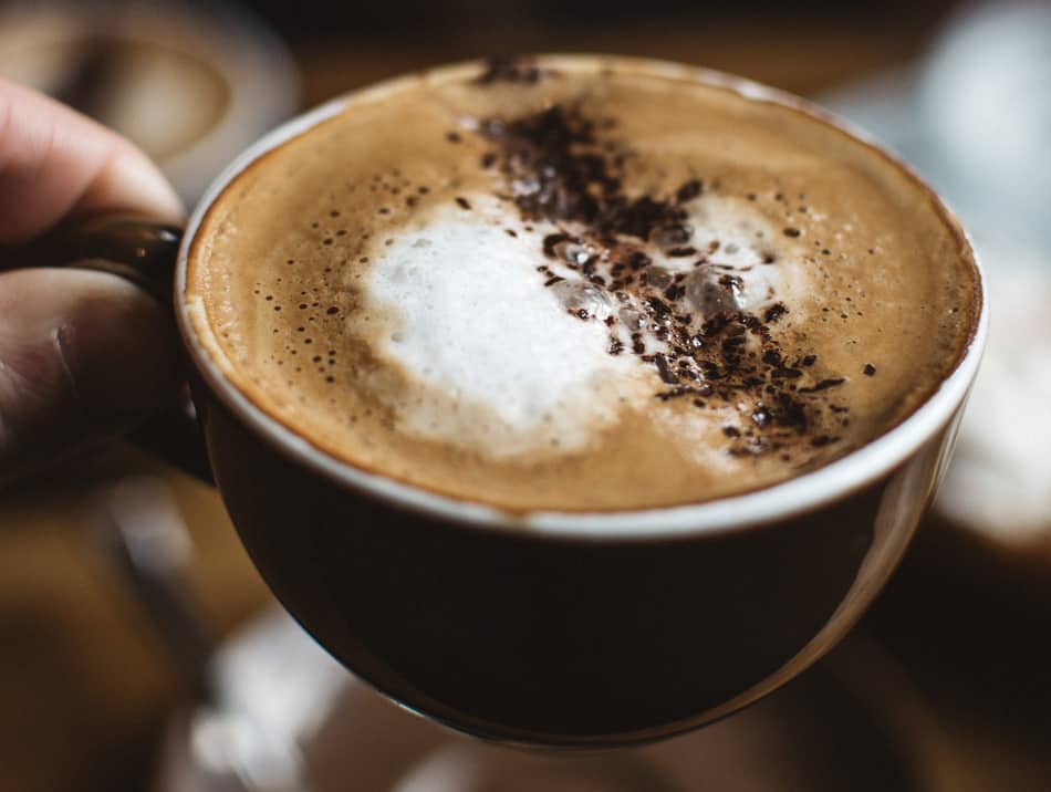 cup of cappuccino coffee with cocoa powder