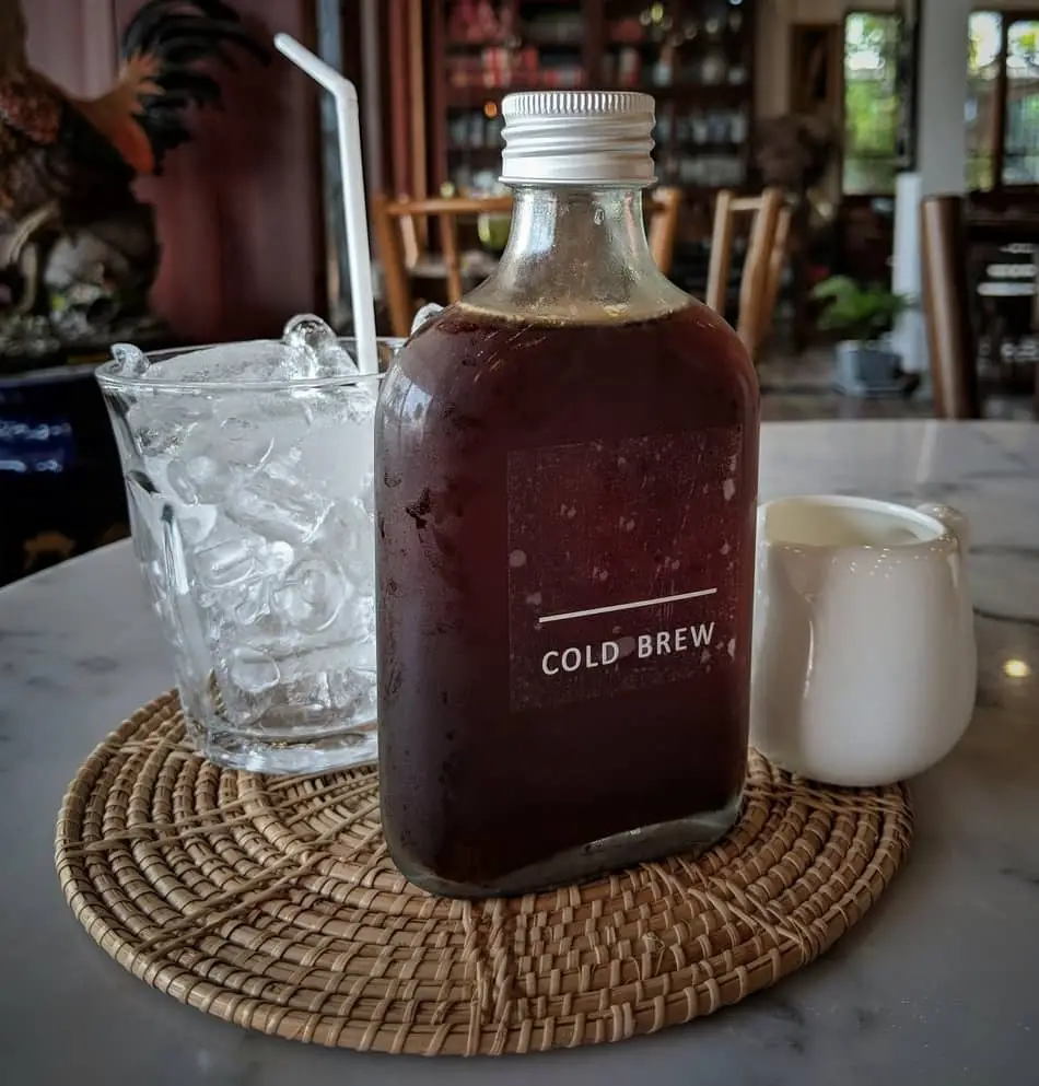 bottle of cold brew next to a glass of ice