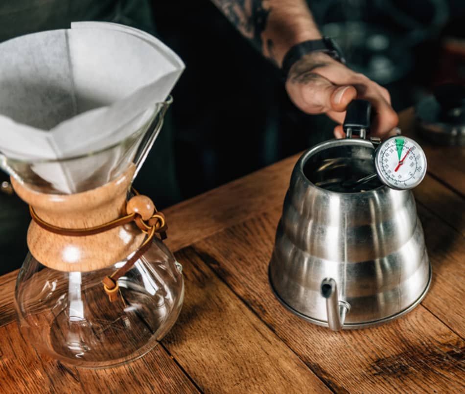 chemex coffeemaker next to gooseneck kettle with analogue temperature probe