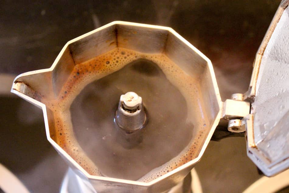 italian moka pot with lid open showing freshly brewed coffee
