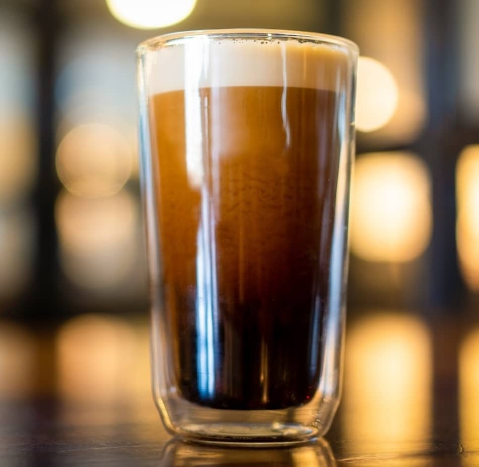 glass of freshly poured nitro cold brew coffee